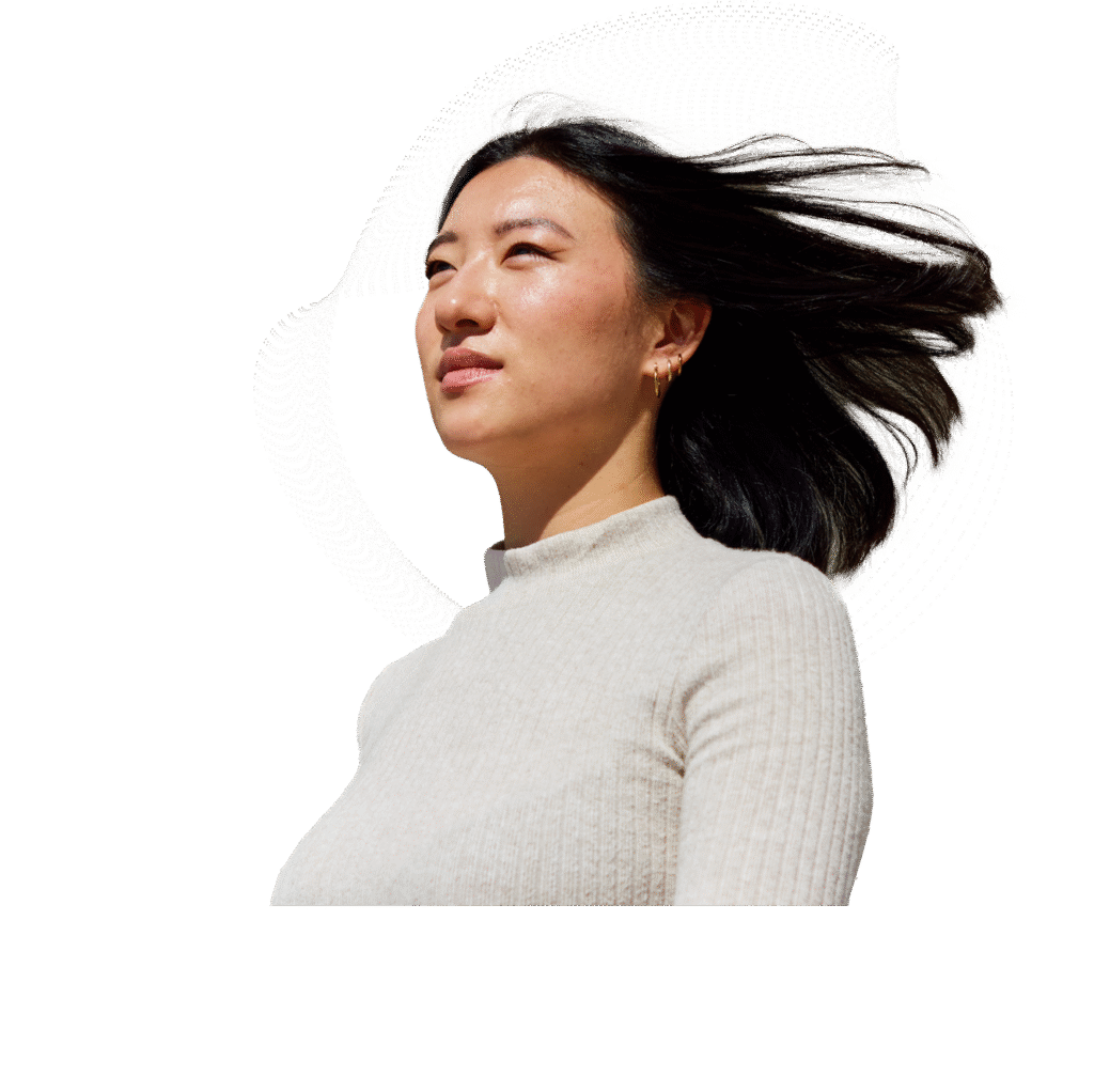 A person looking into the distance with wind in her hair.